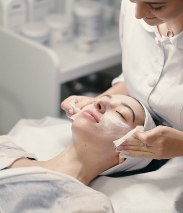 Woman receiving a chemical peel treatment at a skin clinic in Kompally